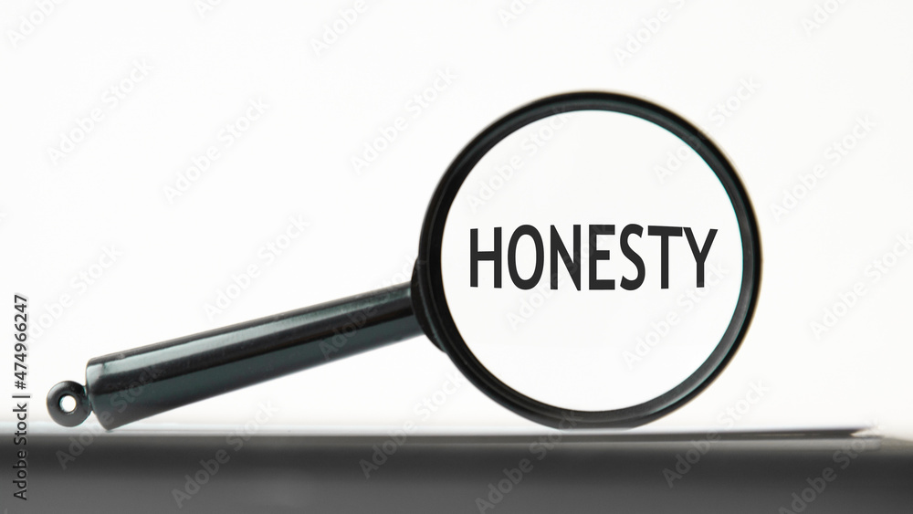 magnifying glass with text honesty on black table magnifying glass with text honesty on black table