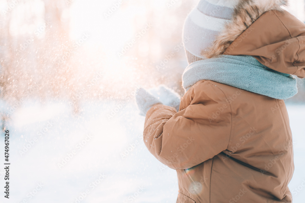 A boy blows snow off his hands winter lifestyle . Winter painting. Snow Park. Cold. A boy blows snow off his hands winter lifestyle . Winter painting. Snow Park. Cold.