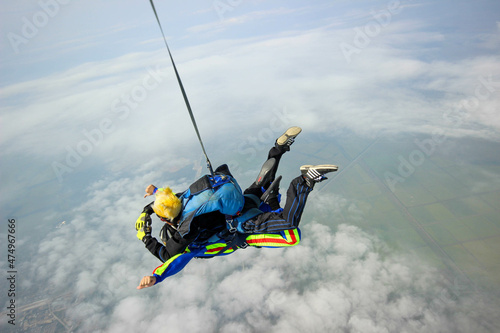 Skydiving. Tandem jump. A man and his instructor are flying across the sky.