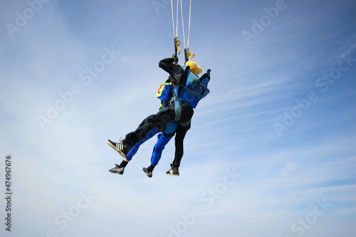 Skydiving. Tandem jump. A man and his instructor are flying across the sky.