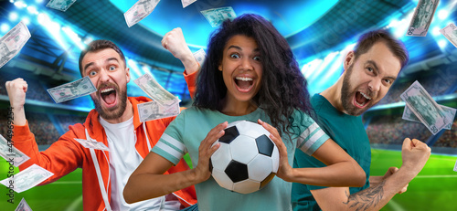 Group of happy soccer fans celebrating money win after betting at favourite team at bookmaker s website  with the stadium and flying dollar banknotes on the background