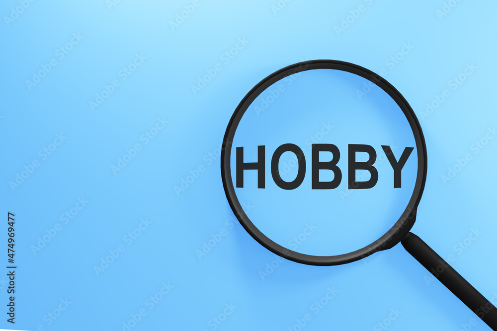 Magnifying glass with the inscription HOBBY on a blue background. Magnifying glass with the inscription HOBBY on a blue background.