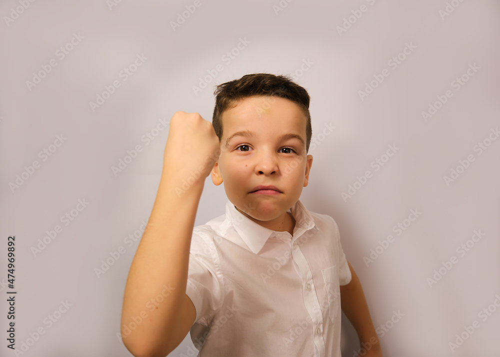 The boy shows his emotion anger shows his fist The boy shows his emotion anger shows his fist