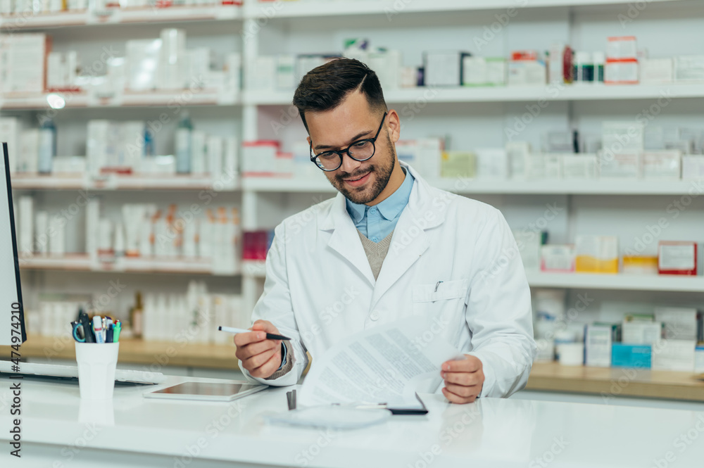 Portrait of a handsome pharmacist working in a pharmacy Portrait of a handsome pharmacist working in a pharmacy