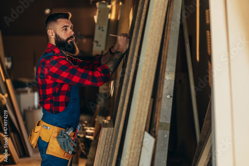 Young male carpenter working in workshop