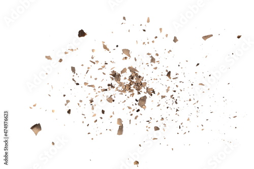 Burned paper scraps scattered, pieces explosion effect isolated on white background and texture, top view