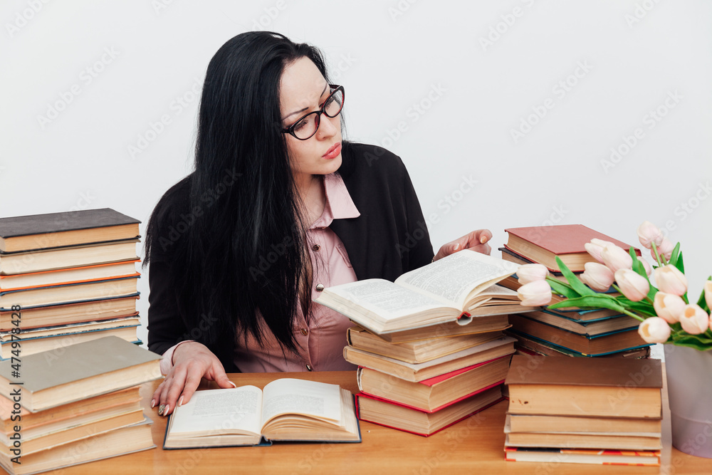 beautiful brunette woman at her desk with books for learning beautiful brunette woman at her desk with books for learning