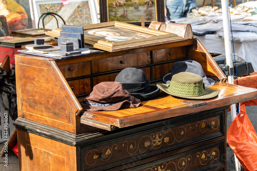 Used hats displayed in a flea market photo