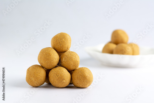 Isolated Stack of Dankwa, (maize-peanut balls) snack and on white ceremic plate Hausa delicacy isolated against a white background photo