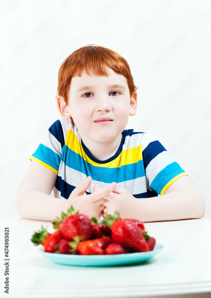 a boy who will soon eat ripe sweet strawberries a boy who will soon eat ripe sweet strawberries