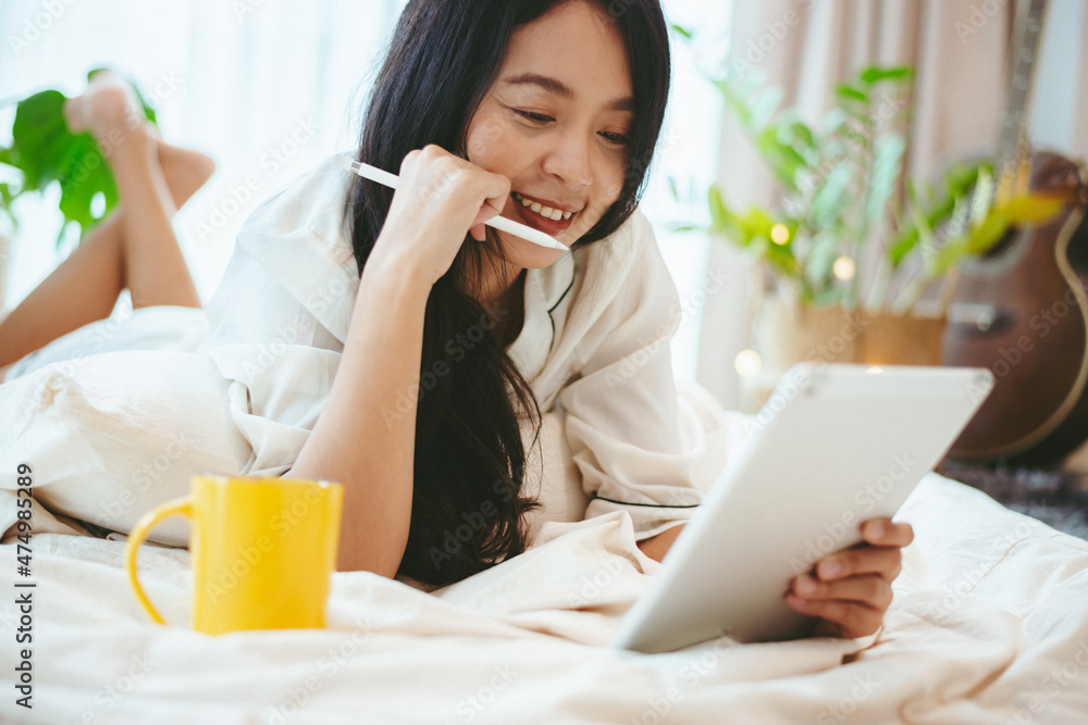 freelance woman working in business by using laptop computer on a bed at home, young girl lifestyle freelance woman working in business by using laptop computer on a bed at home, young girl lifestyle