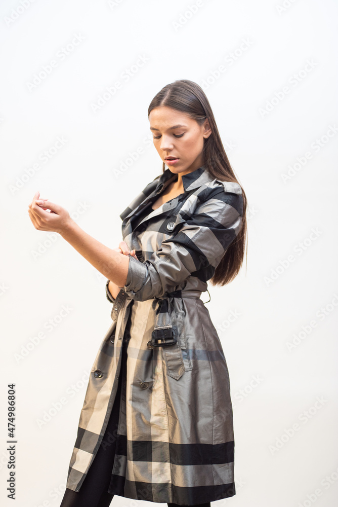 Fashion woman wearing coat and posing on white background Fashion woman wearing coat and posing on white background