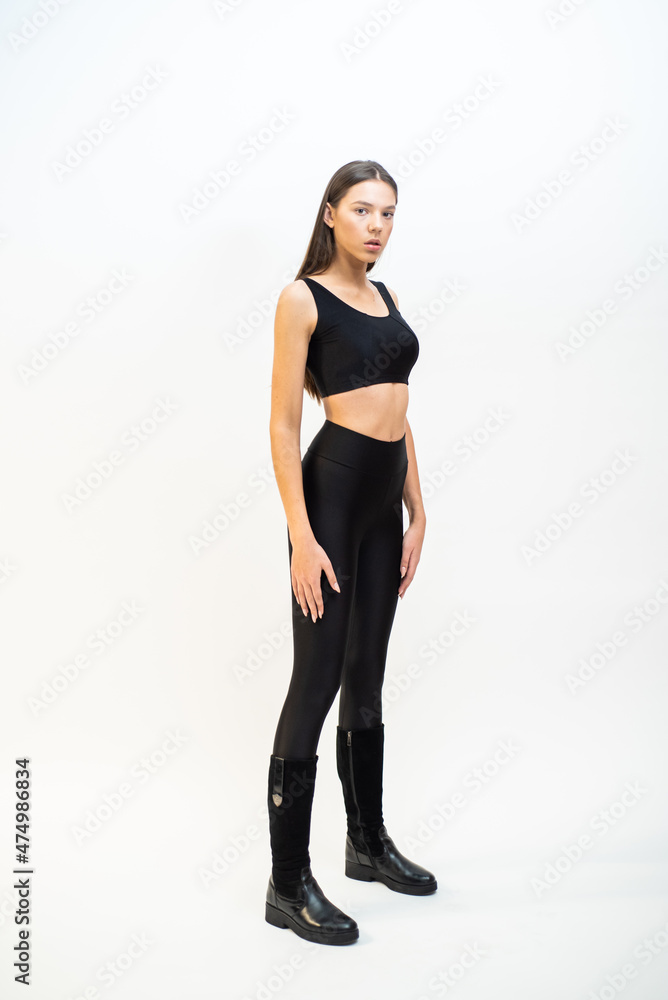 High fashion portrait of young fit elegant woman wearing black clothes. High fashion portrait of young fit elegant woman wearing black clothes.