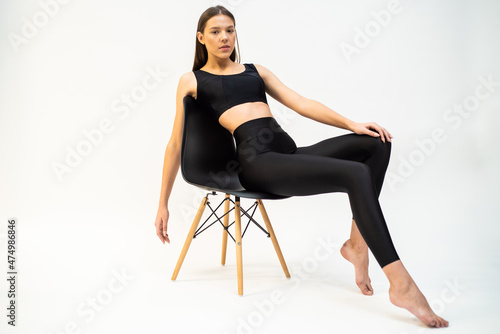 High fashion portrait of young fit elegant woman wearing black clothes.  © alipko