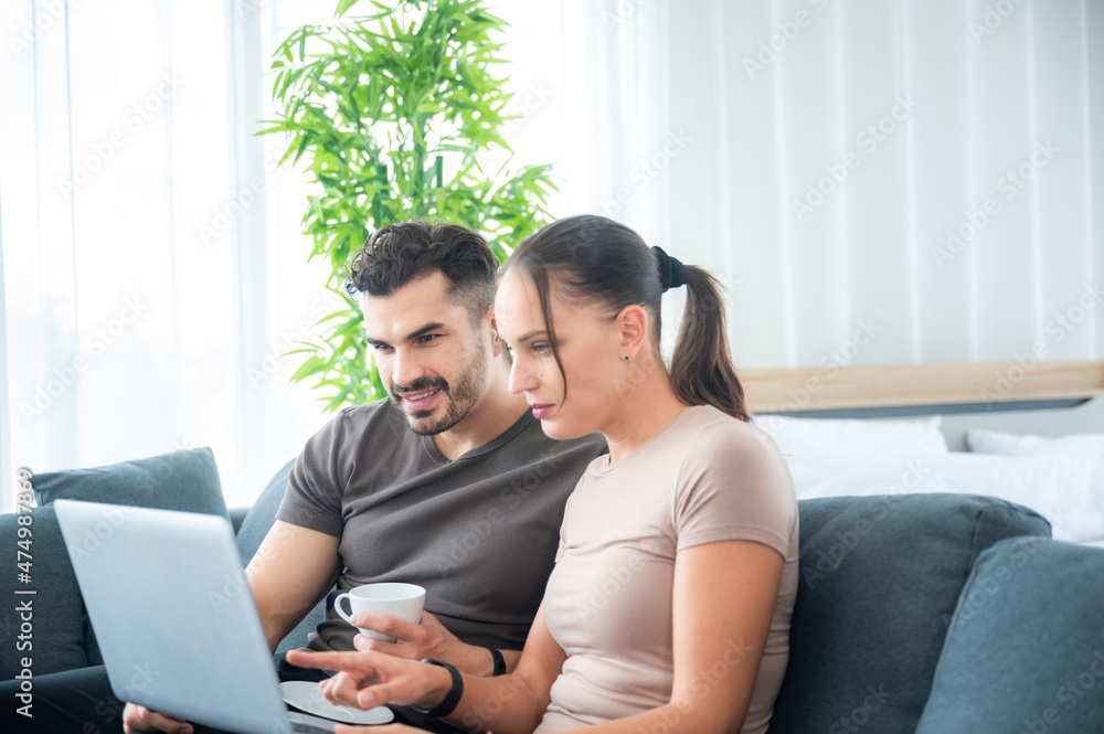 woman and man couple working online with laptop for business work at home, happy indoor lifestyle woman and man couple working online with laptop for business work at home, happy indoor lifestyle