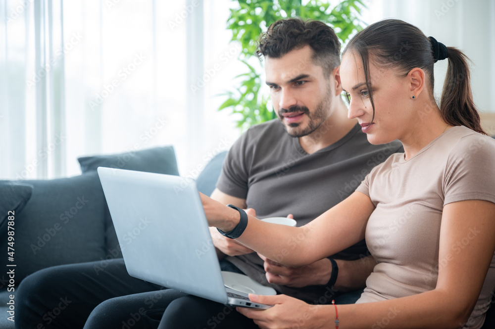 woman and man couple working online with laptop for business work at home, happy indoor lifestyle woman and man couple working online with laptop for business work at home, happy indoor lifestyle
