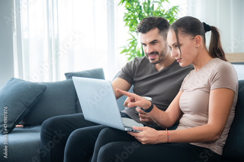 woman and man couple working online with laptop for business work at home, happy indoor lifestyle © chokniti