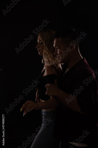 woman and man dancing to music in the dark