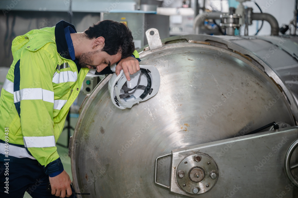 desperate and sad concept, engineer man person who working hard job in industrial factory