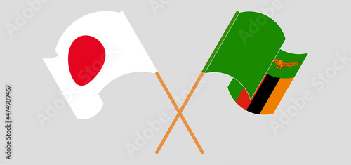 Crossed and waving flags of Japan and Republic of Zambia