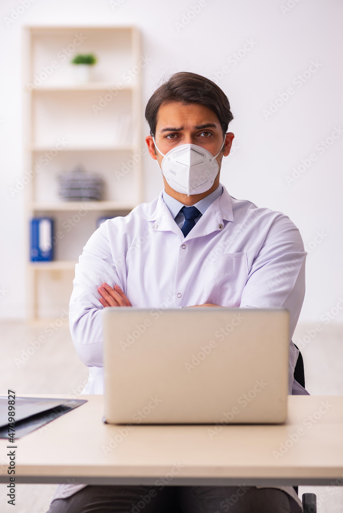 Young male doctor in telemedicine concept during pandemic Young male doctor in telemedicine concept during pandemic