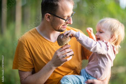 Father and a baby daughter during mushroom picking