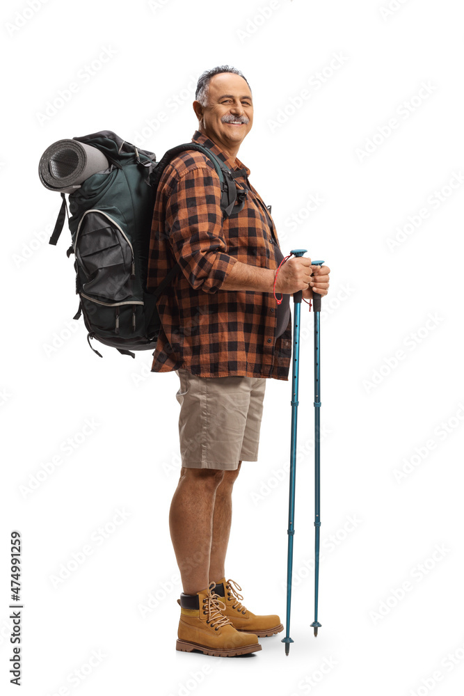 Full length shot of a smiling mature man with a backpack and hiking poles Full length shot of a smiling mature man with a backpack and hiking poles