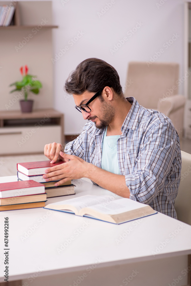 Young male student preparing for exams at home Young male student preparing for exams at home