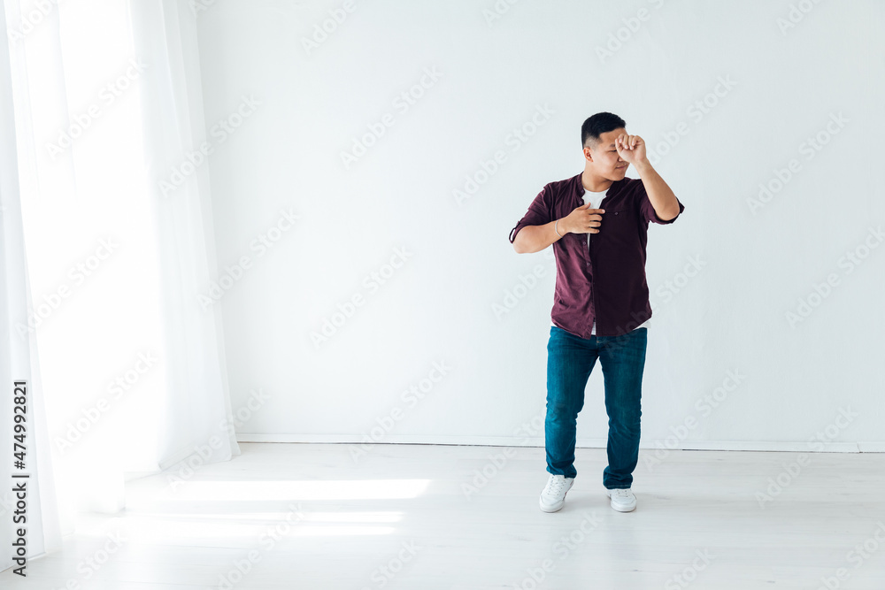 Fototapeta premium man dancing to bachata music in a white hall