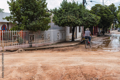 Man riding a bicycle through a Colombian village