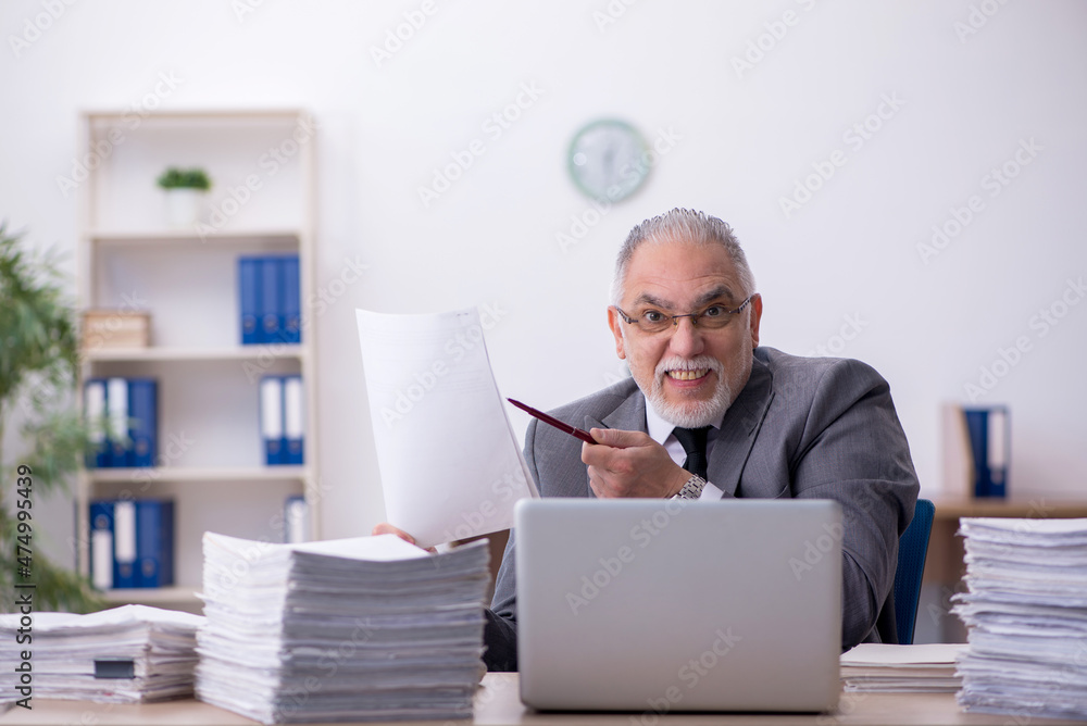 Old male employee and too much work in the office Old male employee and too much work in the office