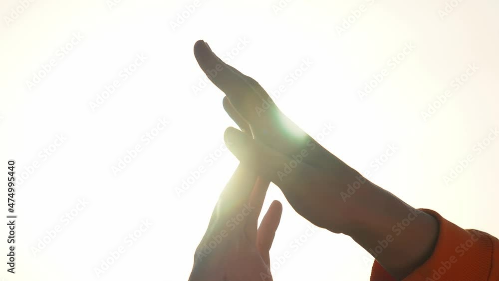 hands couple a close-up. hands men and women symbol love teamwork. silhouette hands support stroking each other close-up. happy family sunlight together teamwork hands couple a close-up. hands men and women symbol love teamwork. silhouette hands support stroking each other close-up. happy family sunlight together teamwork