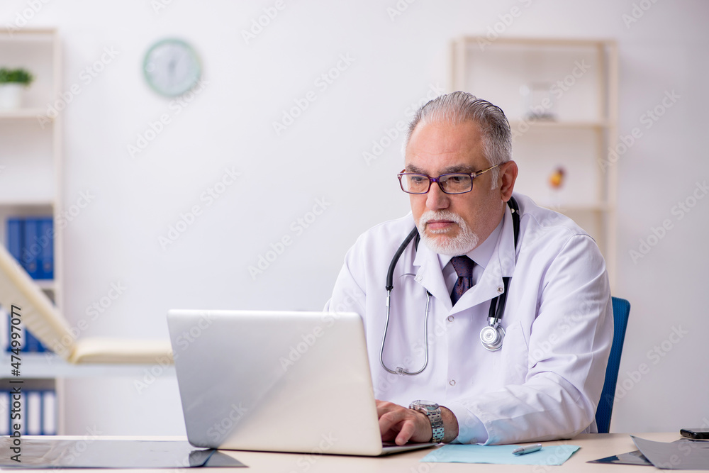 Old male doctor working at the hospital Old male doctor working at the hospital