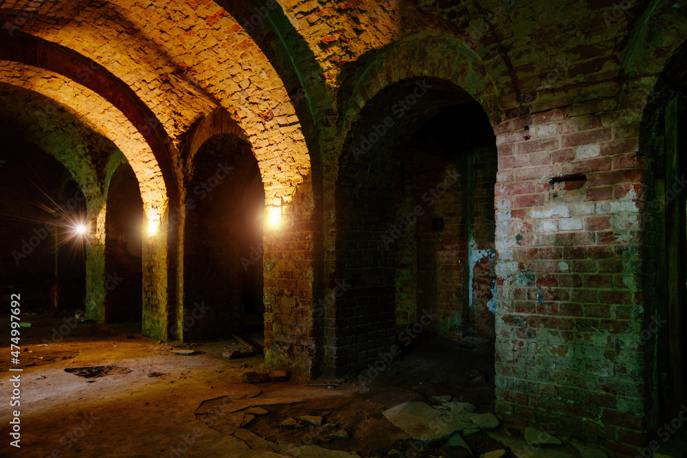 Naklejka premium Vaulted red brick dungeon under old castle
