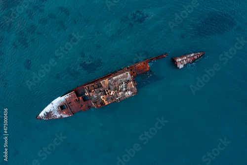 A large sea-going dry-cargo vessel was thrown ashore in a strong storm wind, breaking it into two parts, a fishing vessel thrown onto the coastal bank. The dry cargo ship lies on the seabed on the por
