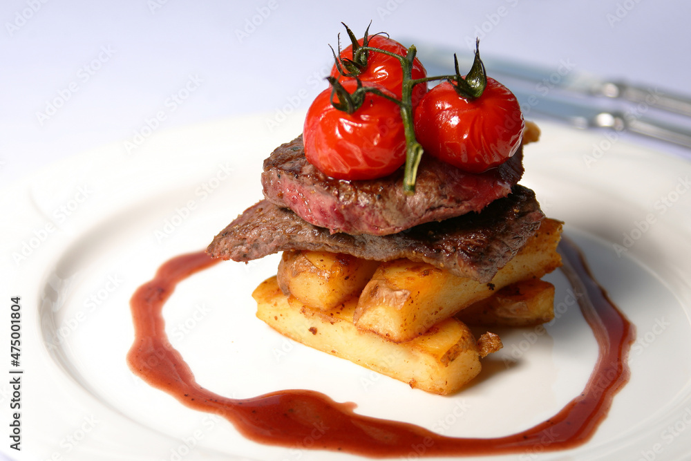Beef steak with tomatoes and french fries Beef steak with tomatoes and french fries