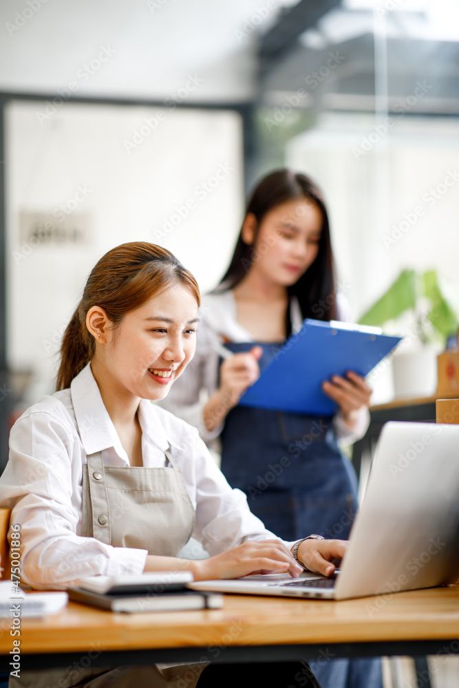 Two Asian young woman working together for SME project. Young Owner people startup for Business Online, SME, Delivery Project. Online Business and Small business Concept Two Asian young woman working together for SME project. Young Owner people startup for Business Online, SME, Delivery Project. Online Business and Small business Concept