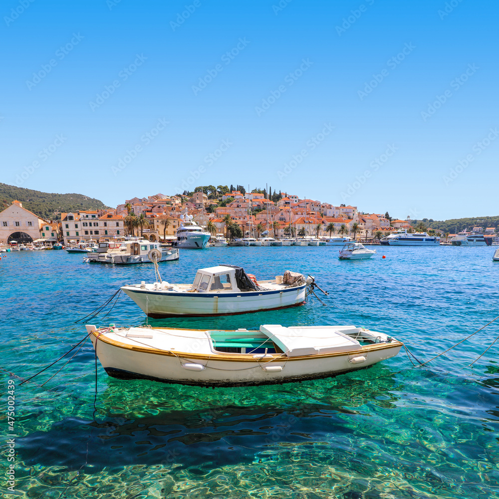 Colorful boats in the crystal clear water of Hvar harbor