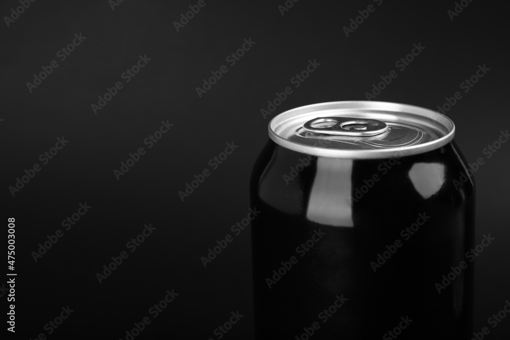 Can of energy drink on black background, closeup. Space for text Can of energy drink on black background, closeup. Space for text