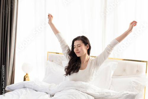 Young woman waking up in the morning