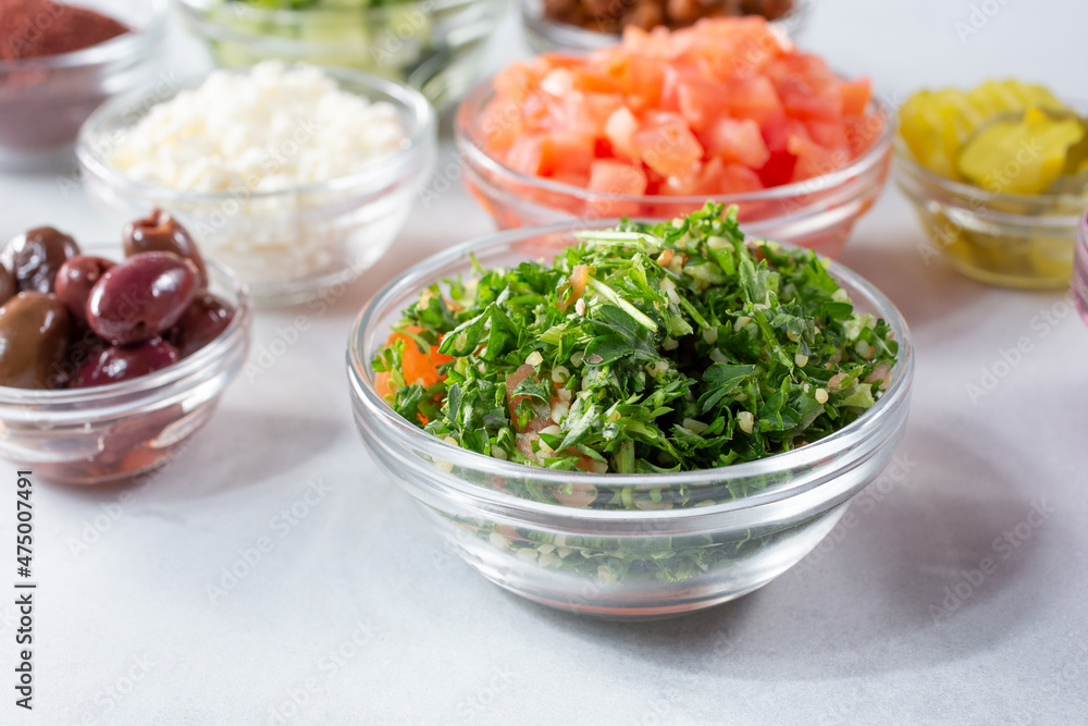 A view of a glass cup of tabbouleh, among other ingredients. A view of a glass cup of tabbouleh, among other ingredients.