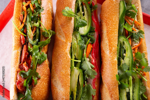 Fotografie A top down view of a three banh mi sandwiches.