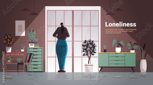 sad woman depressed girl standing in front of window loneliness and isolation depressive disorder problem