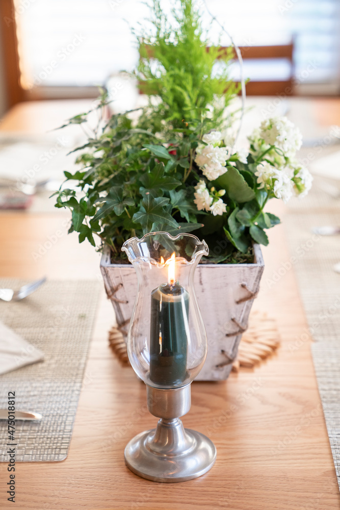 Holiday table decoration with candles and plants