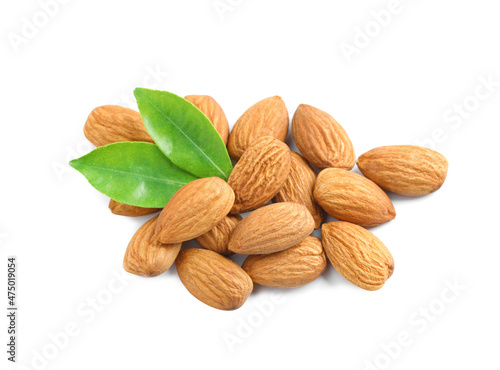 Organic almond nuts and green leaves on white background. Healthy snack