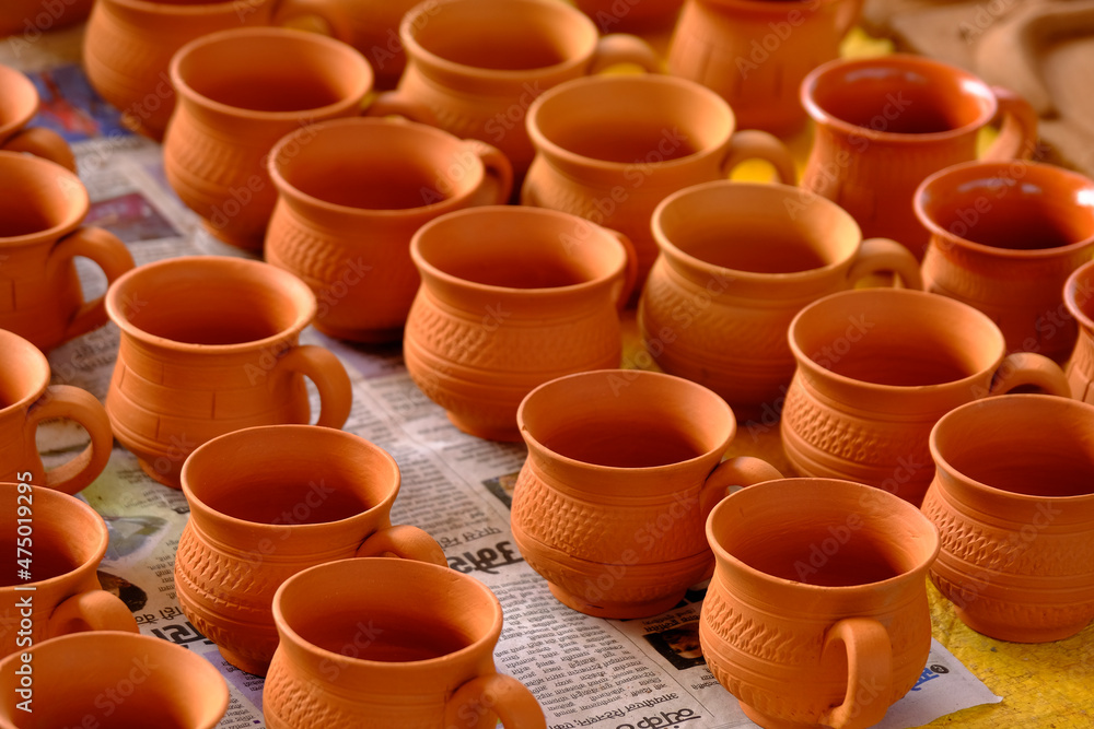 Terracotta, pot, cup kitchen souvenirs pile at street handicraft pottery shop. handmade terracotta Products in handicraft market in Pune, India. Terracotta, pot, cup kitchen souvenirs pile at street handicraft pottery shop. handmade terracotta Products in handicraft market in Pune, India.