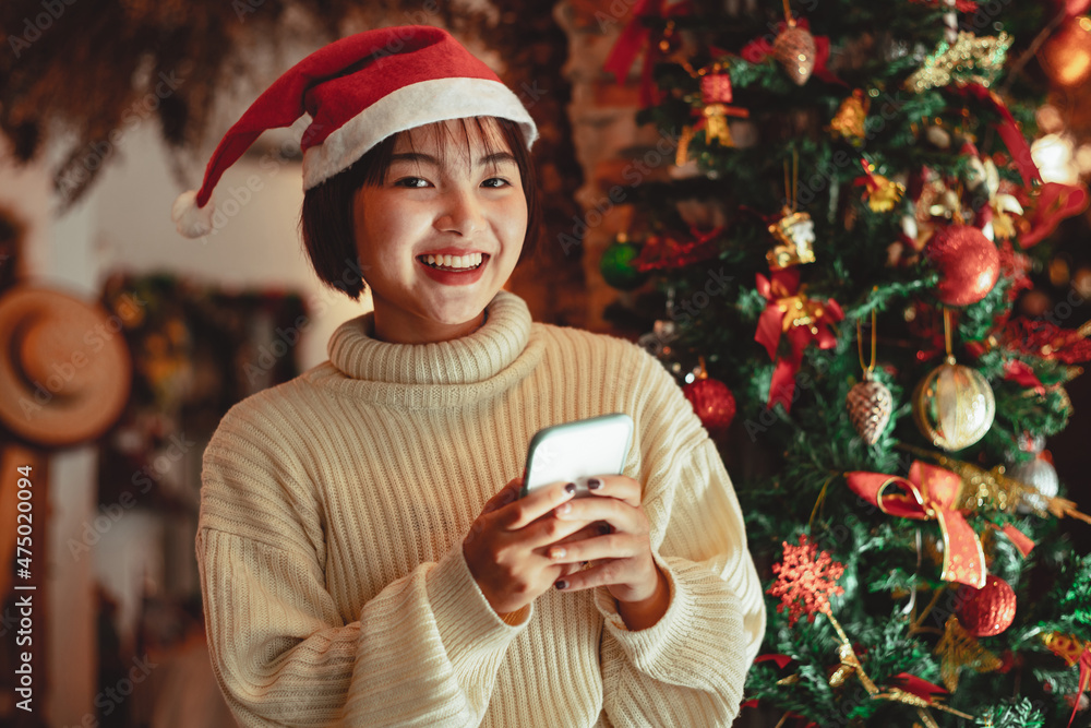 girl use smartphone and enjoy christmas holiday, new year celebration concept girl use smartphone and enjoy christmas holiday, new year celebration concept