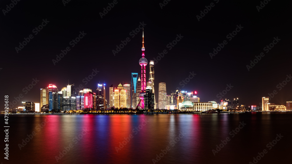 Cityscape of Shanghai at night. Panoramic view of Pudong's skyline from the Bund. Located in Waitan. One of the most famous tourist destinations in Shanghai. Cityscape of Shanghai at night. Panoramic view of Pudong's skyline from the Bund. Located in Waitan. One of the most famous tourist destinations in Shanghai.