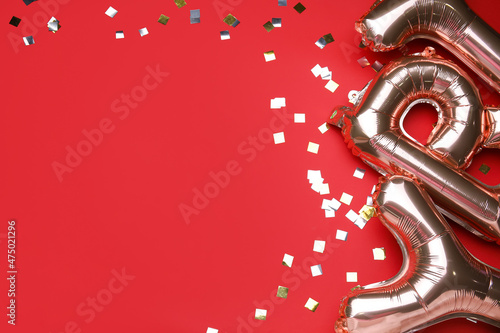 Balloons in shape of letters on red background