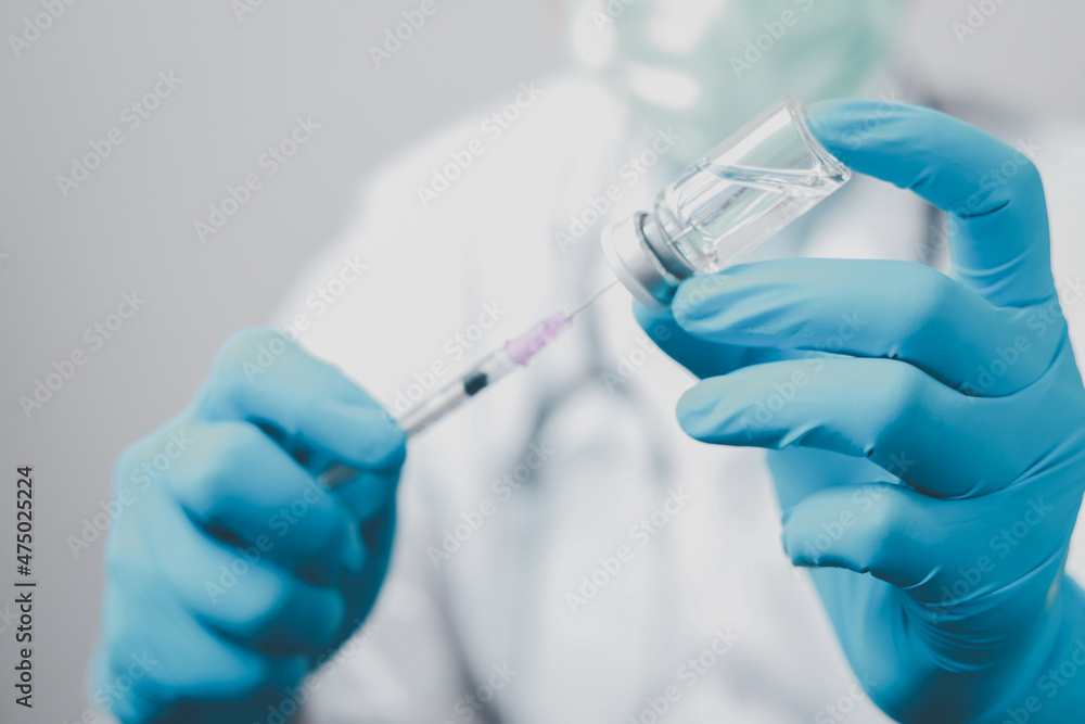 A doctor or scientist in the COVID-19 medical vaccine research and development laboratory holds a syringe with a liquid vaccine to study and analyze antibody samples for the patient.
A doctor or scientist in the COVID-19 medical vaccine research and development laboratory holds a syringe with a liquid vaccine to study and analyze antibody samples for the patient.